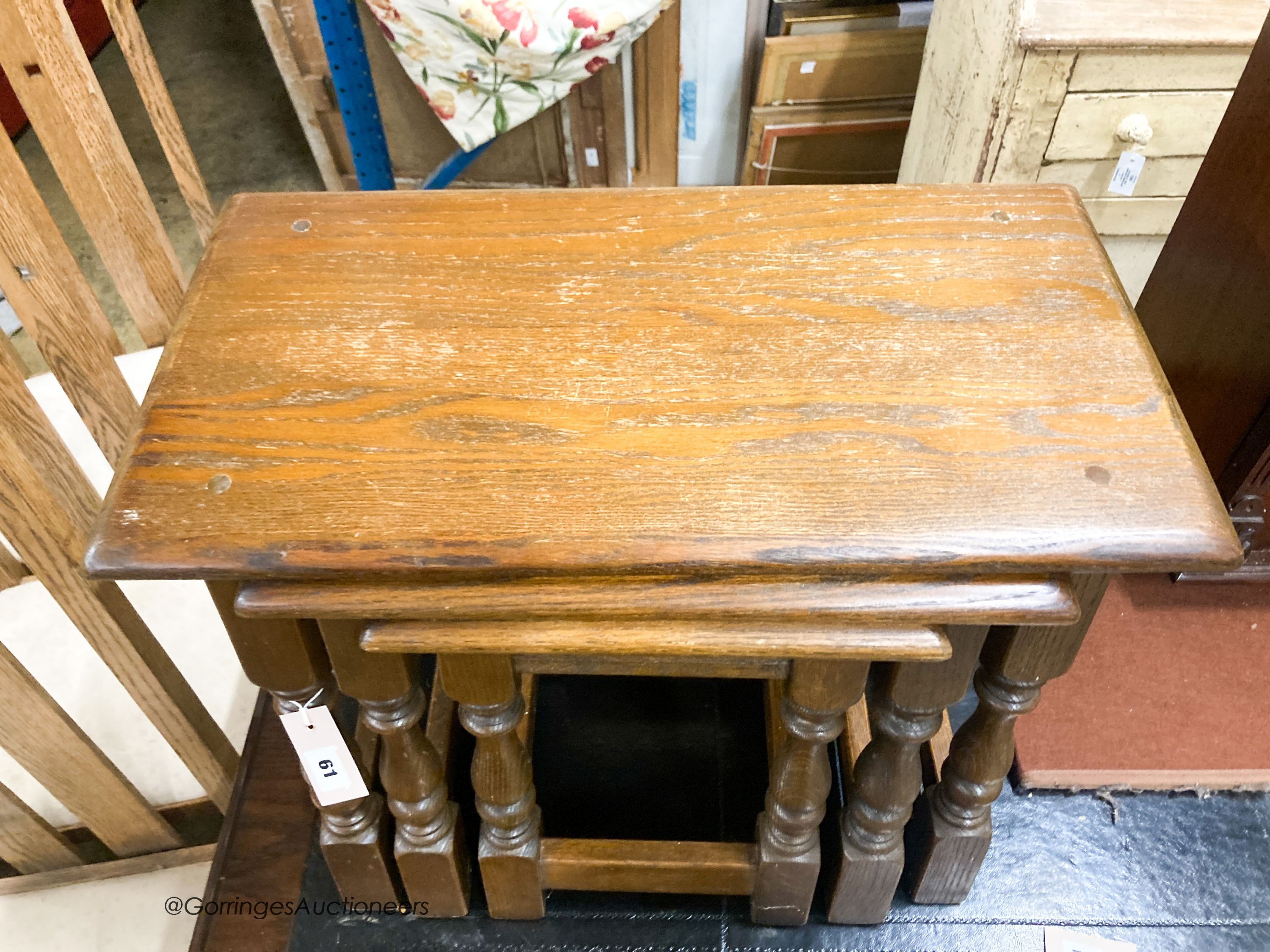 A nest of three reproduction rectangular oak tea tables, largest W.60cm W.32cm H.45cm